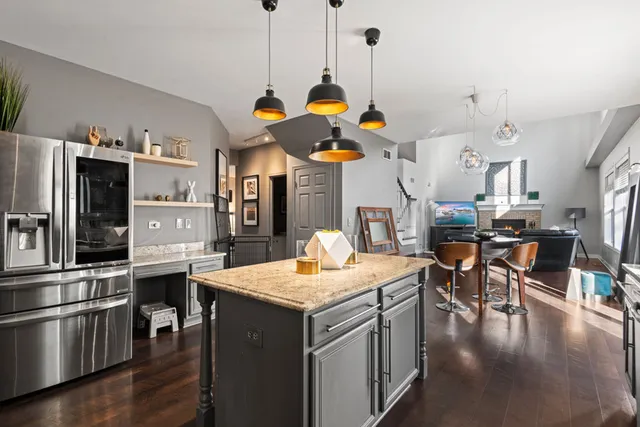 a kitchen with stainless steel appliances granite countertop a stove refrigerator and microwave