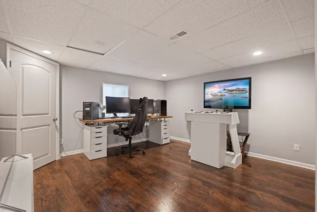 an aerial view of a house with swimming pool and garden