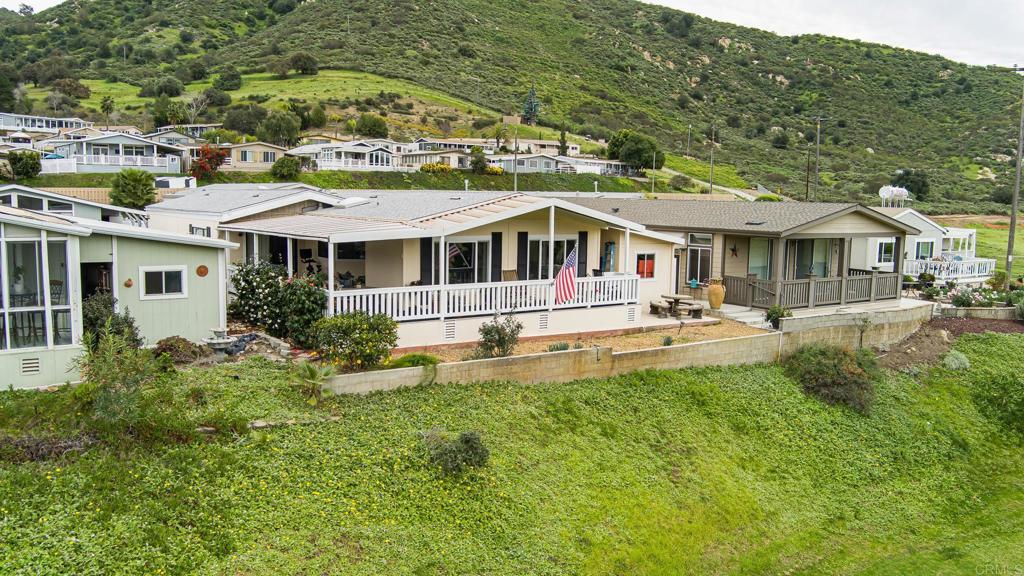 4650 Dulin Road, Unit 229 Fallbrook, CA 92003 - Photo 1 of 53 a front view of a house with a yard table and chairs