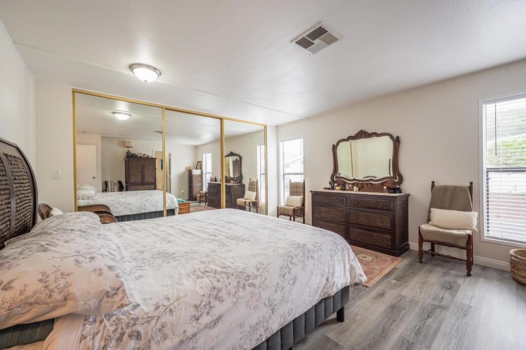 4650 Dulin Road, Unit 229 Fallbrook, CA 92003 - Photo 11 of 53 a bedroom with a bed and a dresser in it