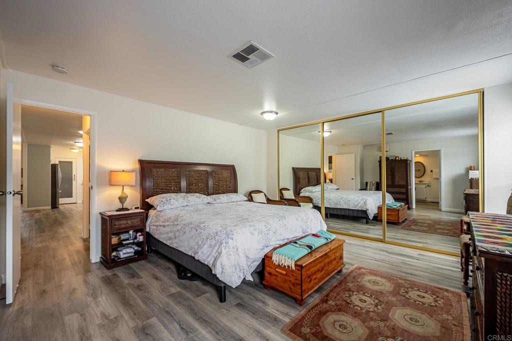 4650 Dulin Road, Unit 229 Fallbrook, CA 92003 - Photo 12 of 53 a spacious bedroom with a bed a table and chairs