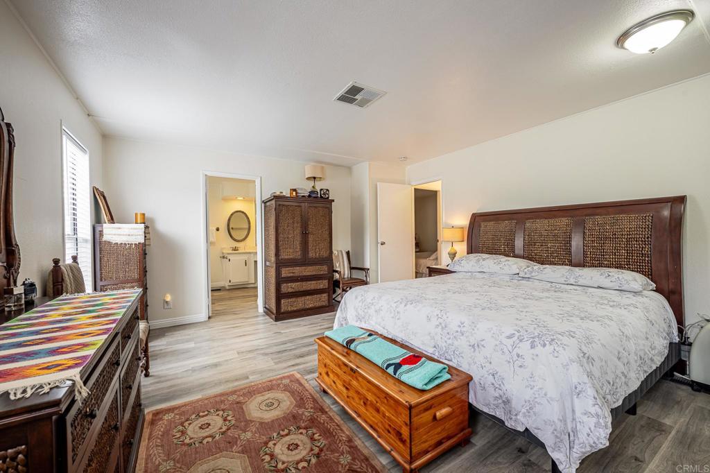 4650 Dulin Road, Unit 229 Fallbrook, CA 92003 - Photo 13 of 53 a bedroom with bed and wooden floor