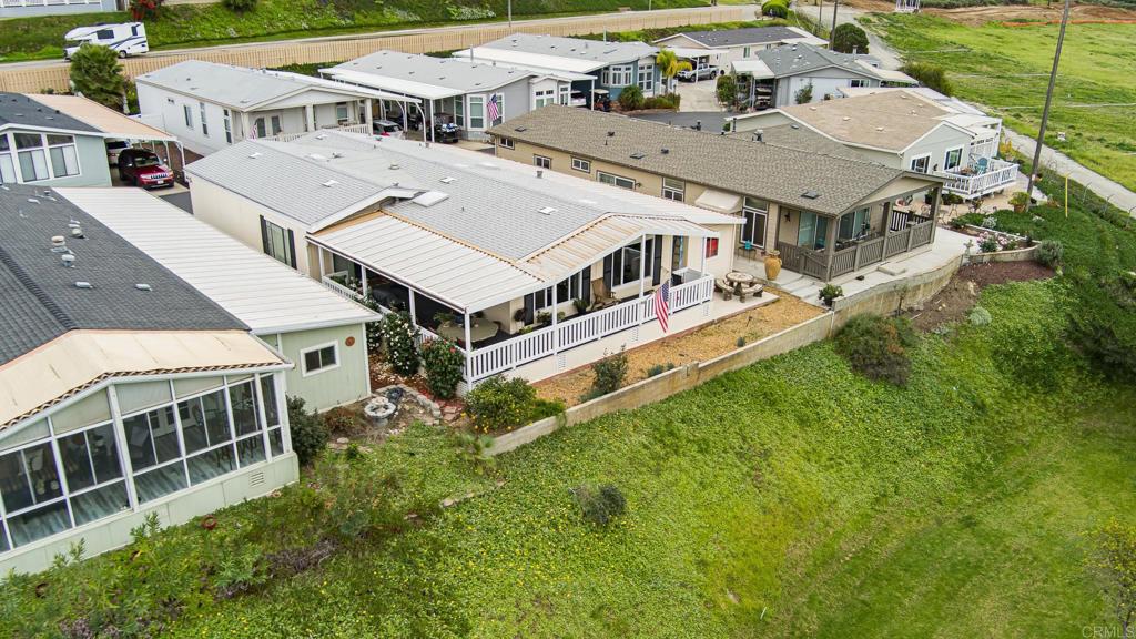 4650 Dulin Road, Unit 229 Fallbrook, CA 92003 - Photo 31 of 53 an aerial view of residential houses with yard and trees