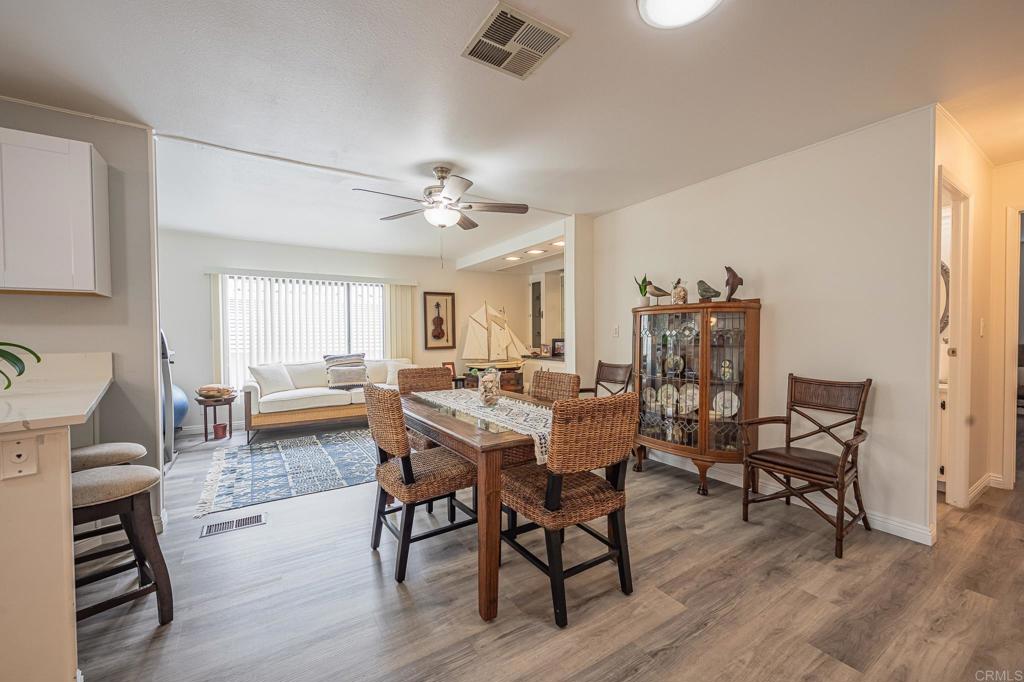 4650 Dulin Road, Unit 229 Fallbrook, CA 92003 - Photo 35 of 53 a view of a dining room with furniture and wooden floor