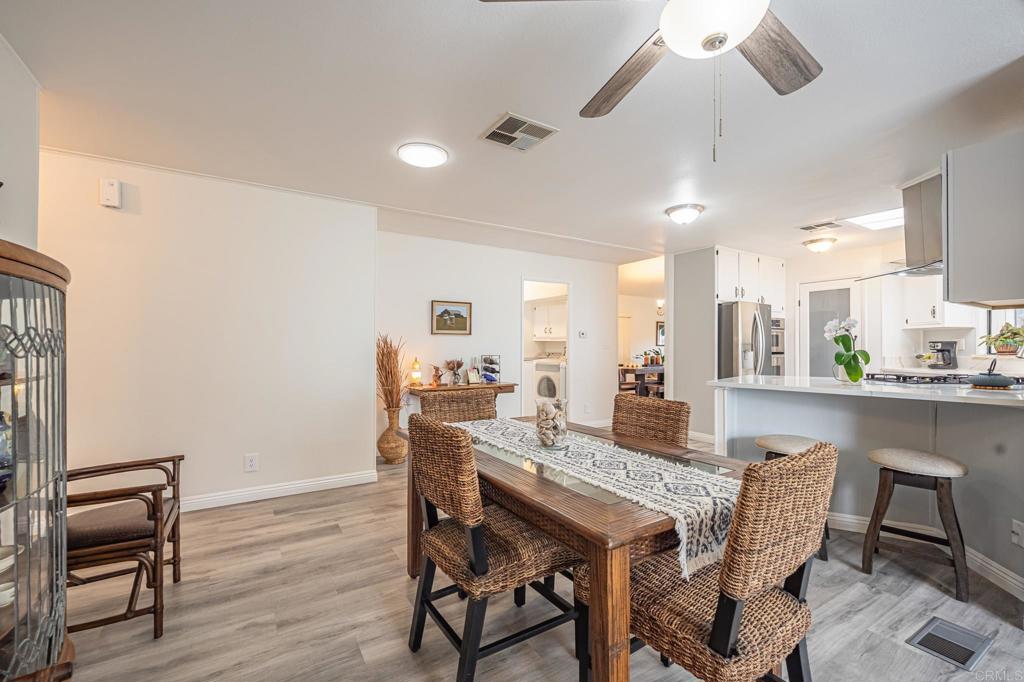 4650 Dulin Road, Unit 229 Fallbrook, CA 92003 - Photo 36 of 53 a view of a dining room with furniture and wooden floor
