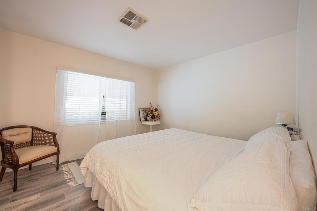 4650 Dulin Road, Unit 229 Fallbrook, CA 92003 - Photo 38 of 53 a bedroom with a bed a chair and window