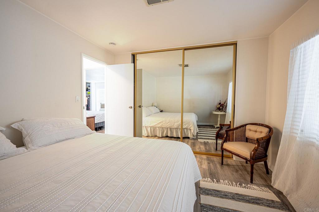 4650 Dulin Road, Unit 229 Fallbrook, CA 92003 - Photo 39 of 53 a bedroom with a bed and a chandelier