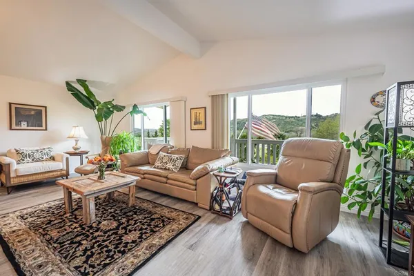 a view of a dining room with furniture wooden floor and a chandelier