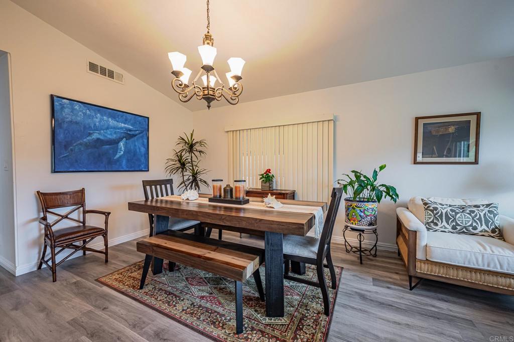 4650 Dulin Road, Unit 229 Fallbrook, CA 92003 - Photo 6 of 53 a view of a dining room with furniture wooden floor and a chandelier