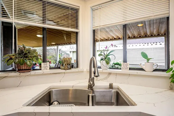 a kitchen with stainless steel appliances a refrigerator and cabinets