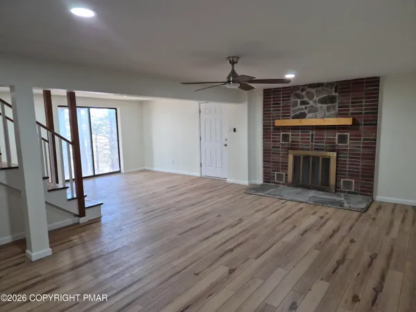a view of a room with wooden floor and bench