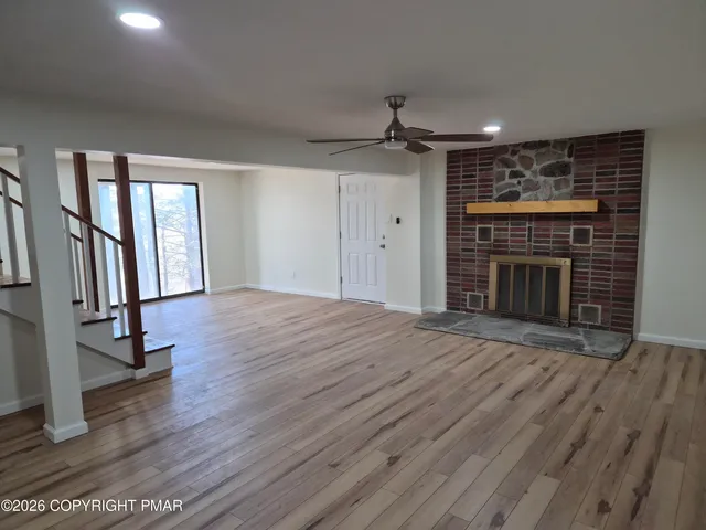 a view of a room with wooden floor and bench