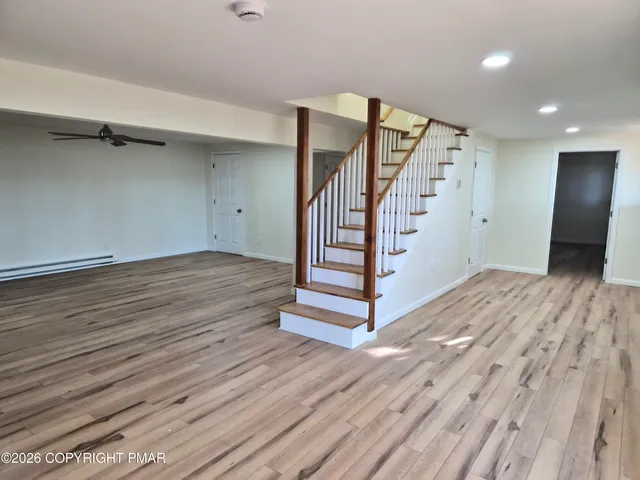 wooden floor in an empty room with a mirror