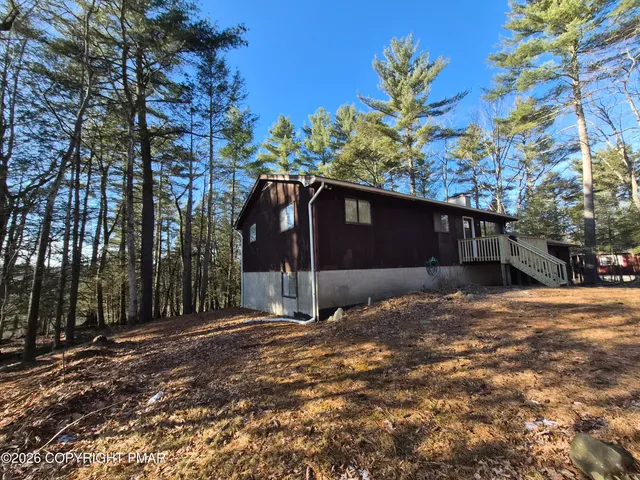 a view of a house with a tree