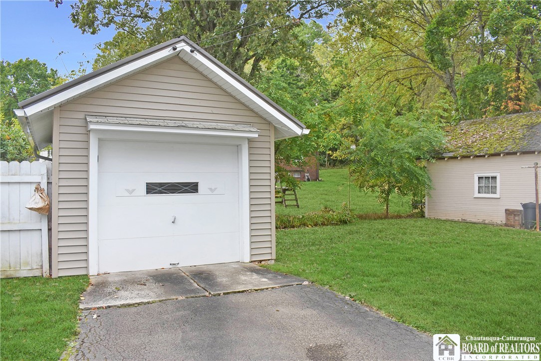 79 Pershing Avenue Jamestown, NY 14701 - Photo 3 of 31 1 car Garage with Black top Driveway