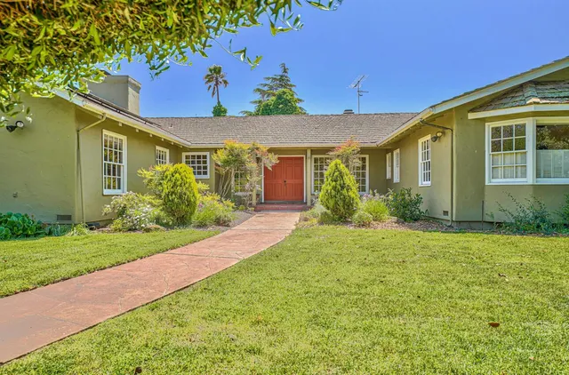 a view of a dining room with furniture large windows and wooden floor