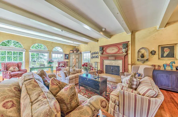 a utility room with stainless steel appliances a sink a stove a washer dryer and white cabinets