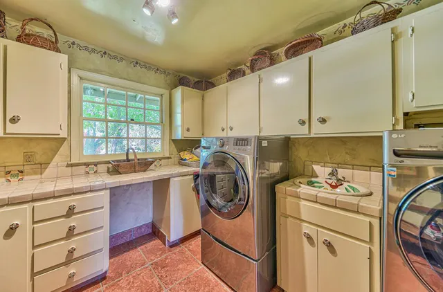 a aerial view of a house next to a city