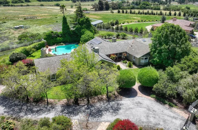 an aerial view of a house with a garden