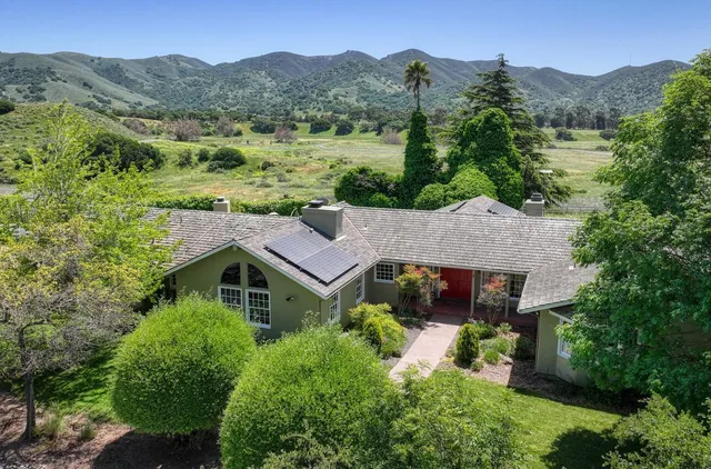 an aerial view of residential house with outdoor space and swimming pool