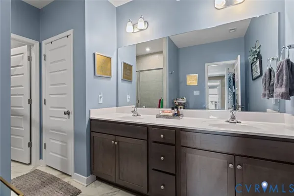 a bathroom with a double vanity sink and mirror