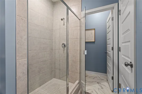 a bathroom with a glass shower door
