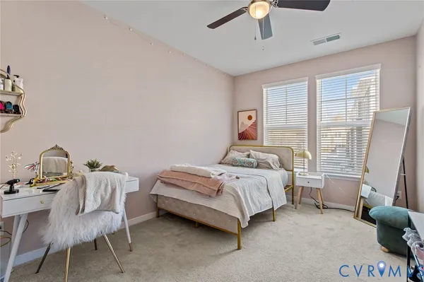a bedroom with a bed chair and window
