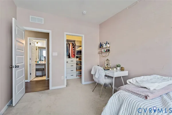 a bedroom with a bed and a chair