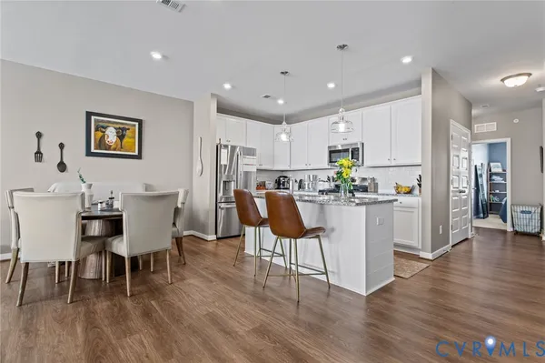 a living room with kitchen island furniture and a wooden floor