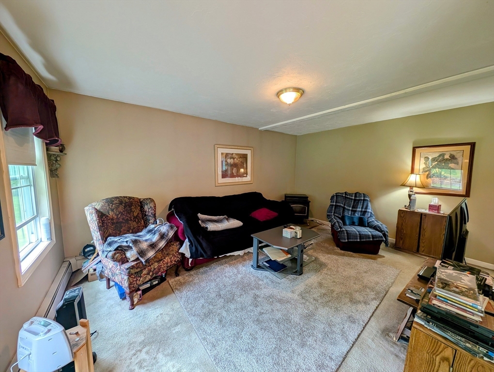 83 Haggerty Road Charlton, MA 01507 - Photo 4 of 32 a living room with furniture and a flat screen tv