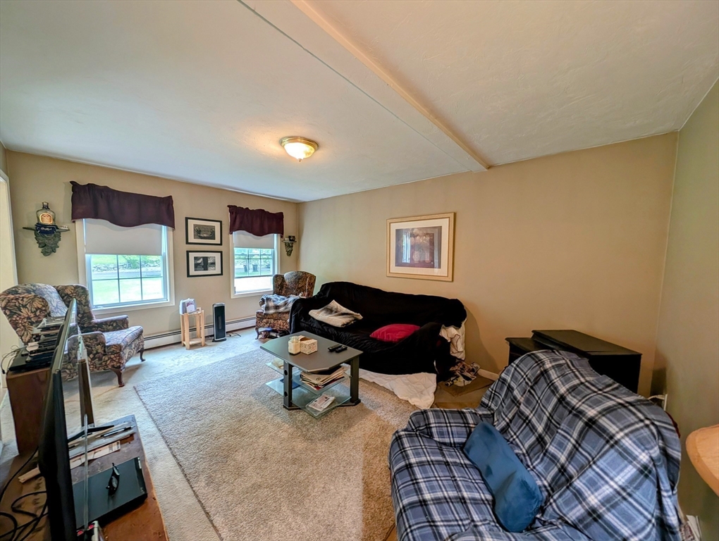 83 Haggerty Road Charlton, MA 01507 - Photo 5 of 32 a living room with furniture a flat screen tv and a window