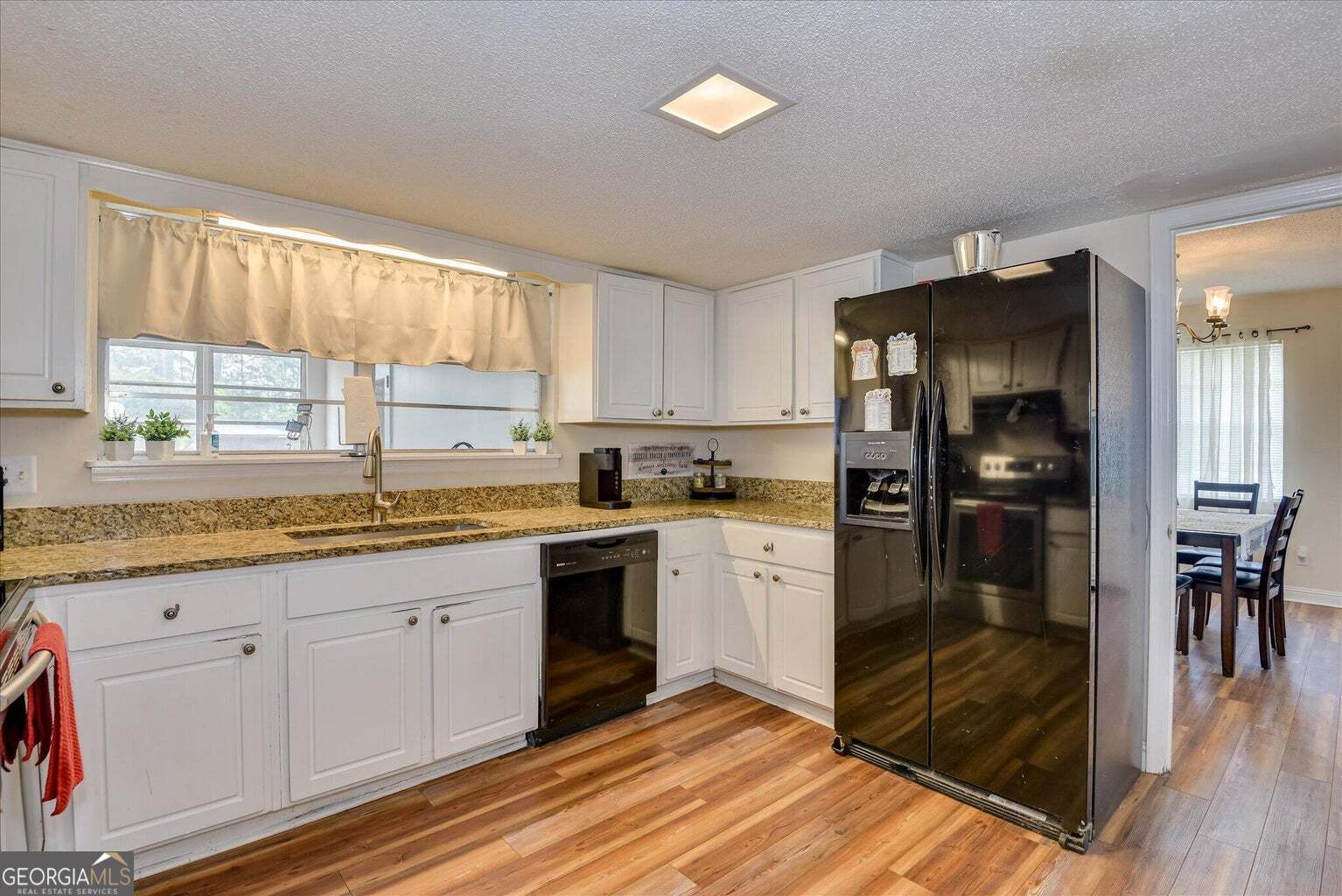 306 Pleasant Home Road Augusta, GA 30907 - Photo 16 of 57 a kitchen with granite countertop a refrigerator and a sink