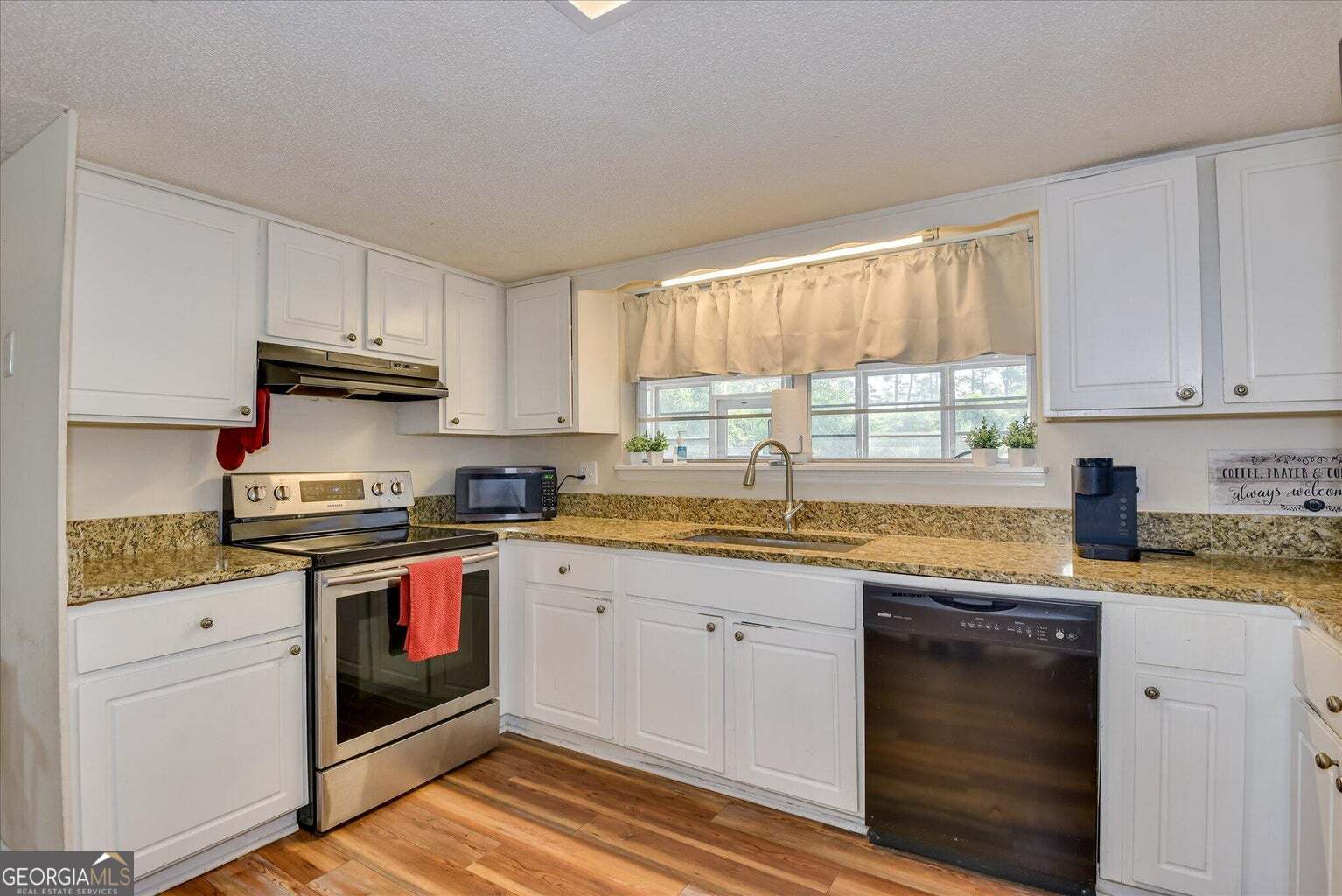 306 Pleasant Home Road Augusta, GA 30907 - Photo 17 of 57 a kitchen with granite countertop cabinets stainless steel appliances and a sink