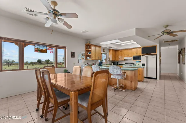 a large kitchen with stainless steel appliances granite countertop a stove a sink and a microwave