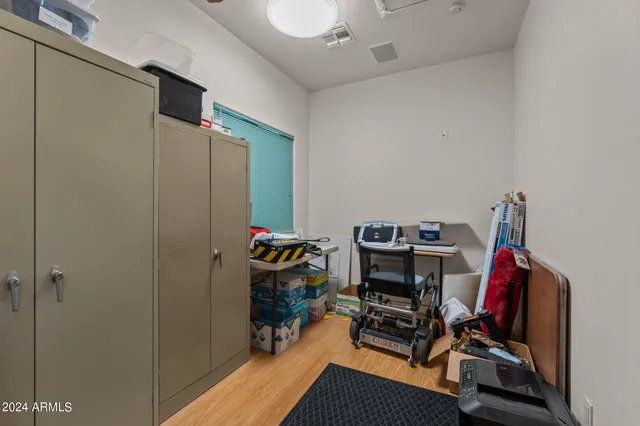 a room with a couch a computer on desk and chair
