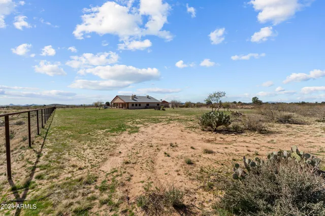 a view of a lake with beach in back