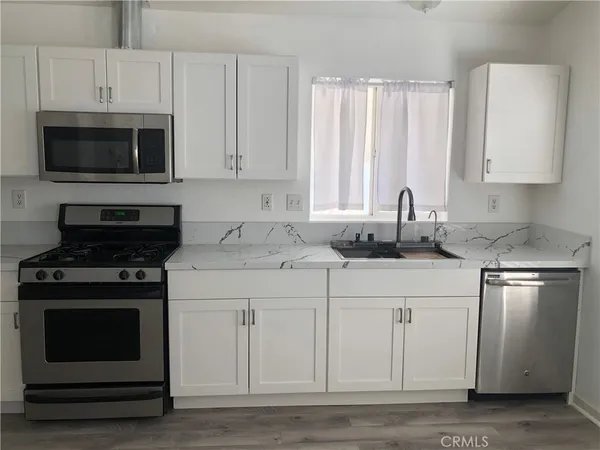 a stove top oven sitting inside of a kitchen