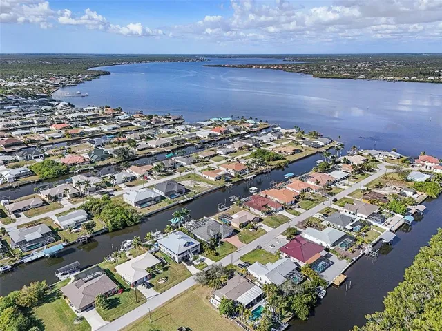 a view of a house with a big yard and large trees