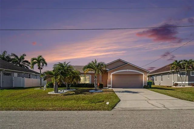 a patio with a table and chairs and potted plants