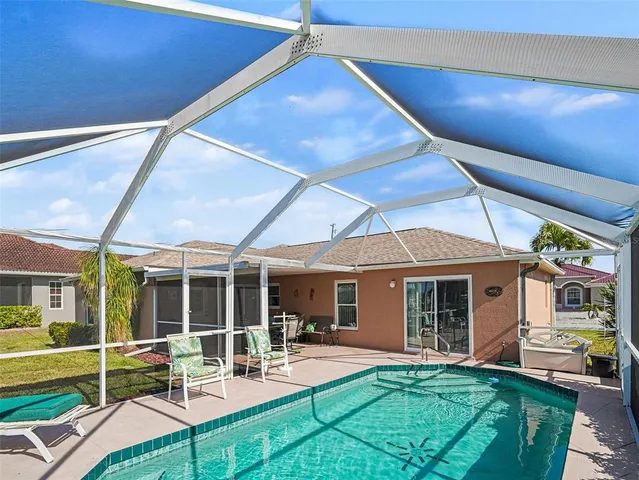 a view of an outdoor sitting area with furniture and garden view