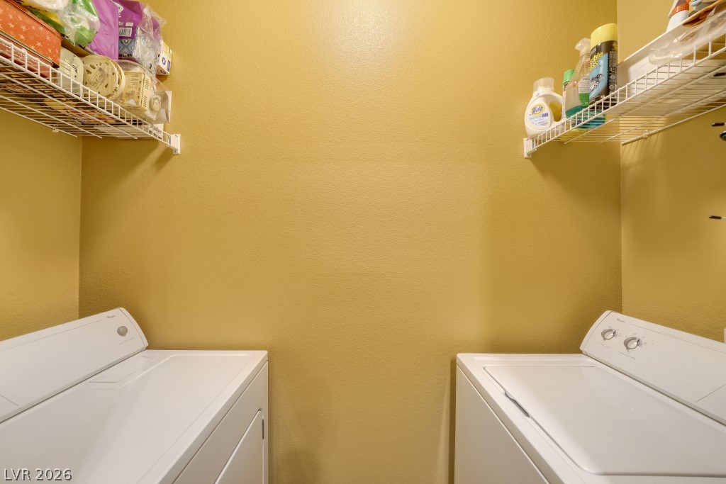 10550 West Alexander Road, Unit 1108 Las Vegas, NV 89129 - Photo 14 of 29 Functional in-unit laundry room setup includes wire shelving overhead.