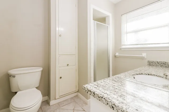 a white toilet sitting next to a bathroom sink