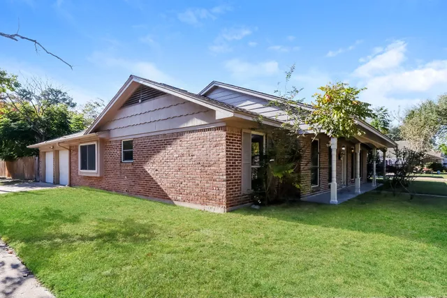 a view of a house with a yard and sitting area