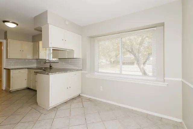 a kitchen with a stove a sink and a refrigerator
