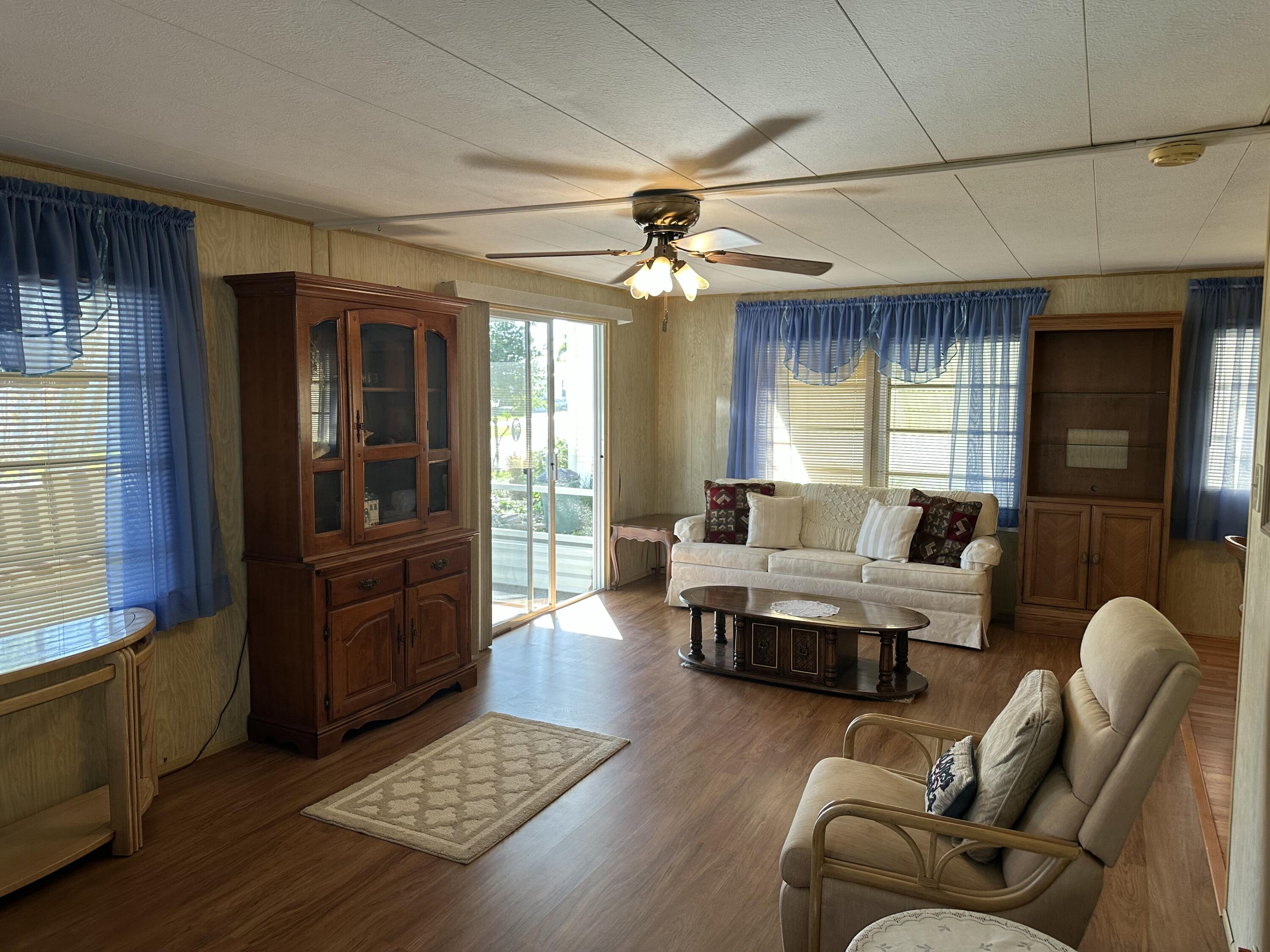 8435 East Club Road Boca Raton, FL 33433 - Photo 16 of 31 a living room with furniture and a window
