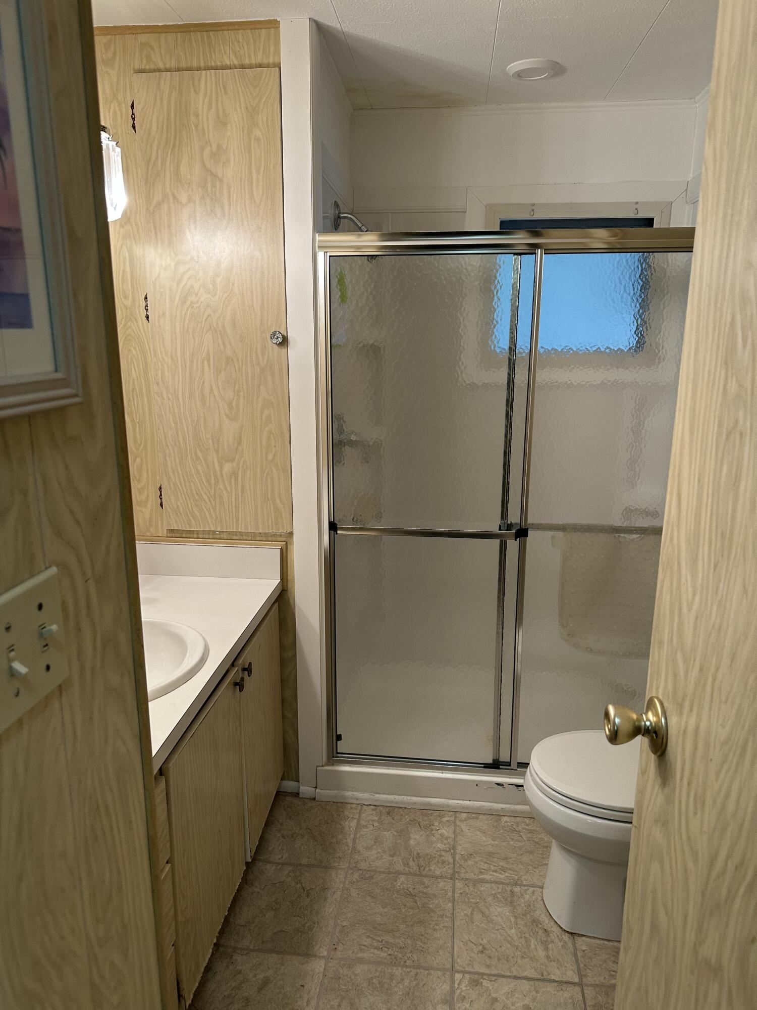 8435 East Club Road Boca Raton, FL 33433 - Photo 17 of 31 a bathroom with a granite countertop sink toilet and shower