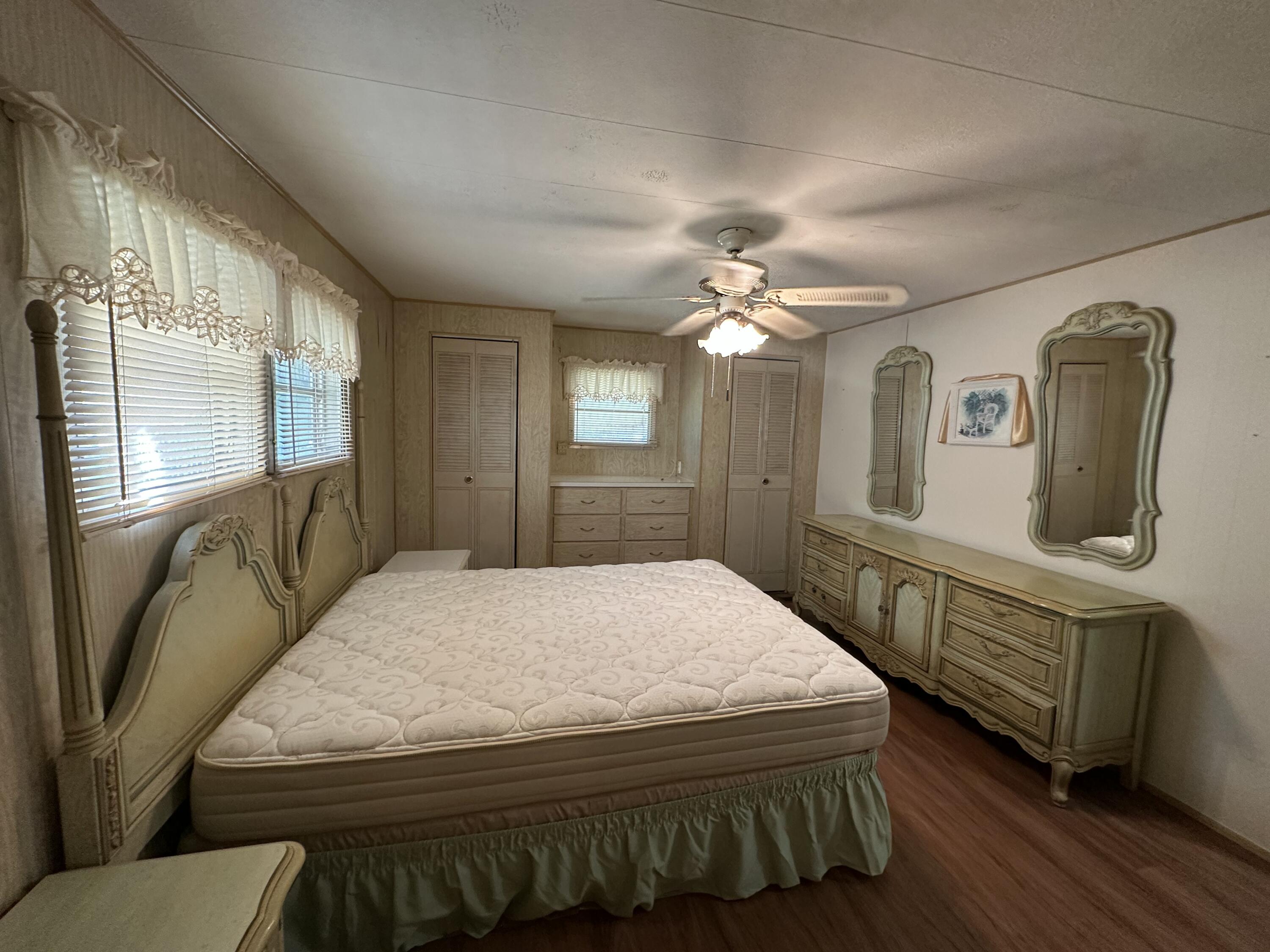 8435 East Club Road Boca Raton, FL 33433 - Photo 20 of 31 a bedroom with a bed mirror and window