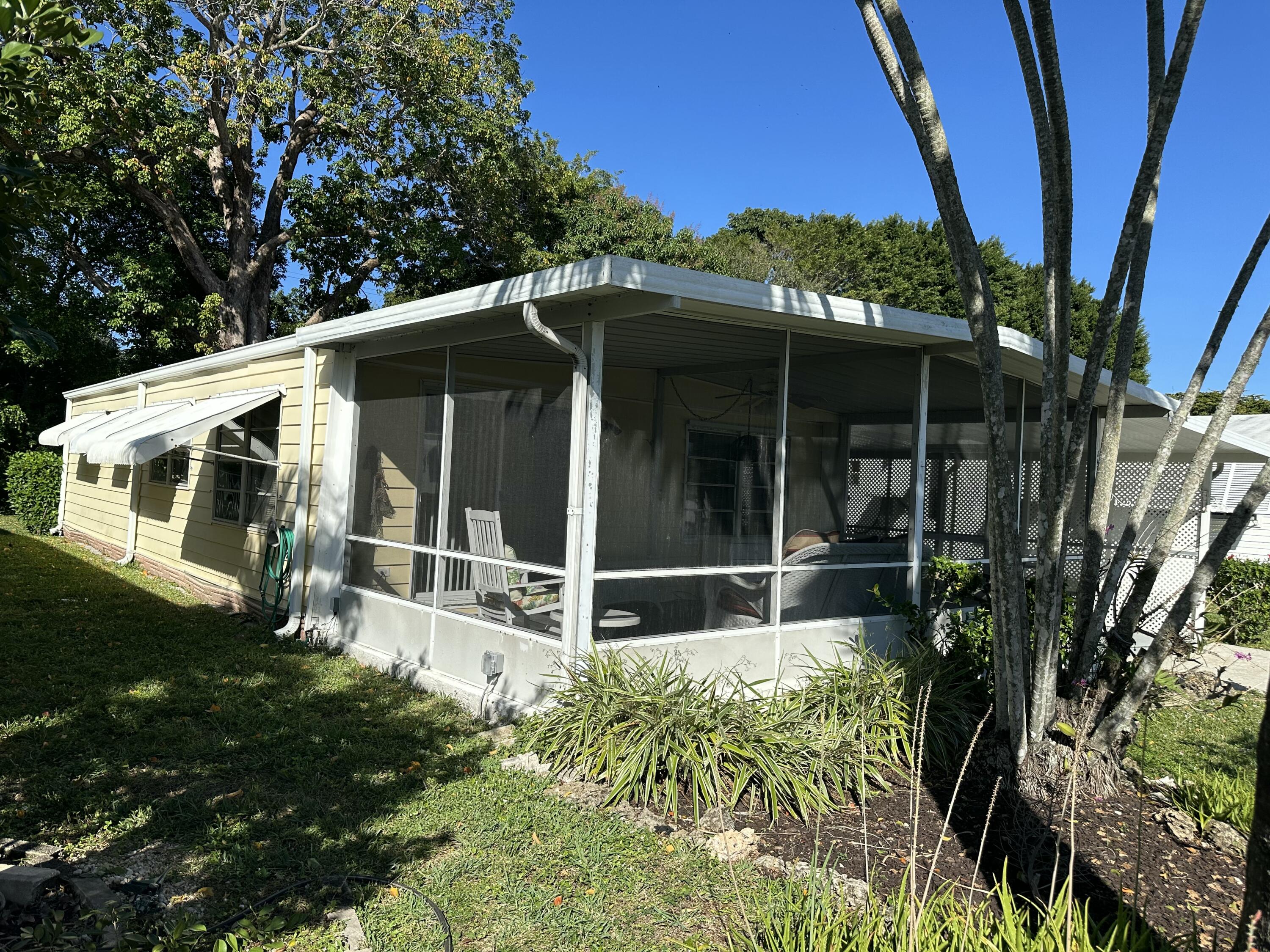8435 East Club Road Boca Raton, FL 33433 - Photo 2 of 31 a view of a house with backyard and sitting area