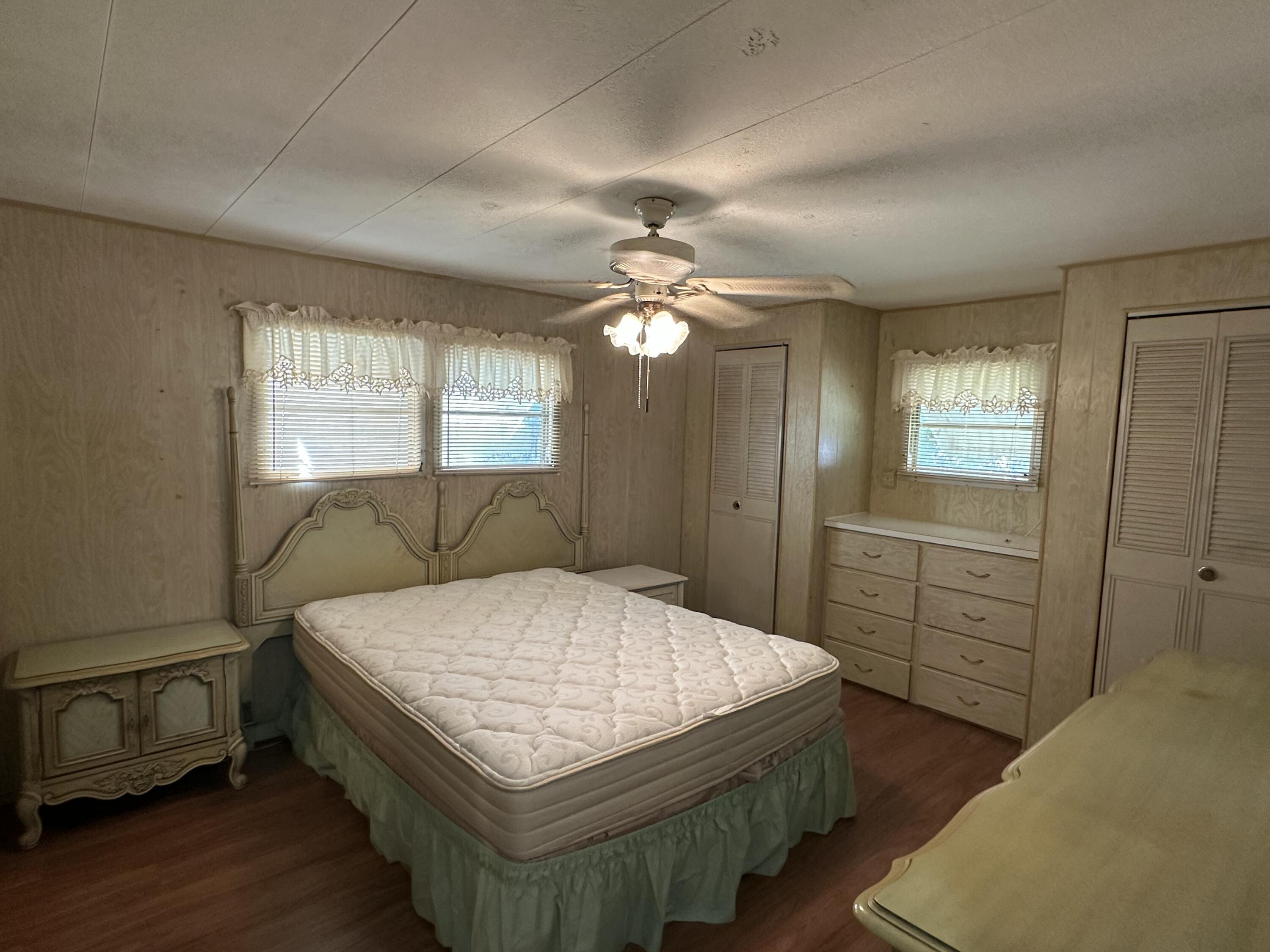 8435 East Club Road Boca Raton, FL 33433 - Photo 21 of 31 a bedroom with a bed and a dresser