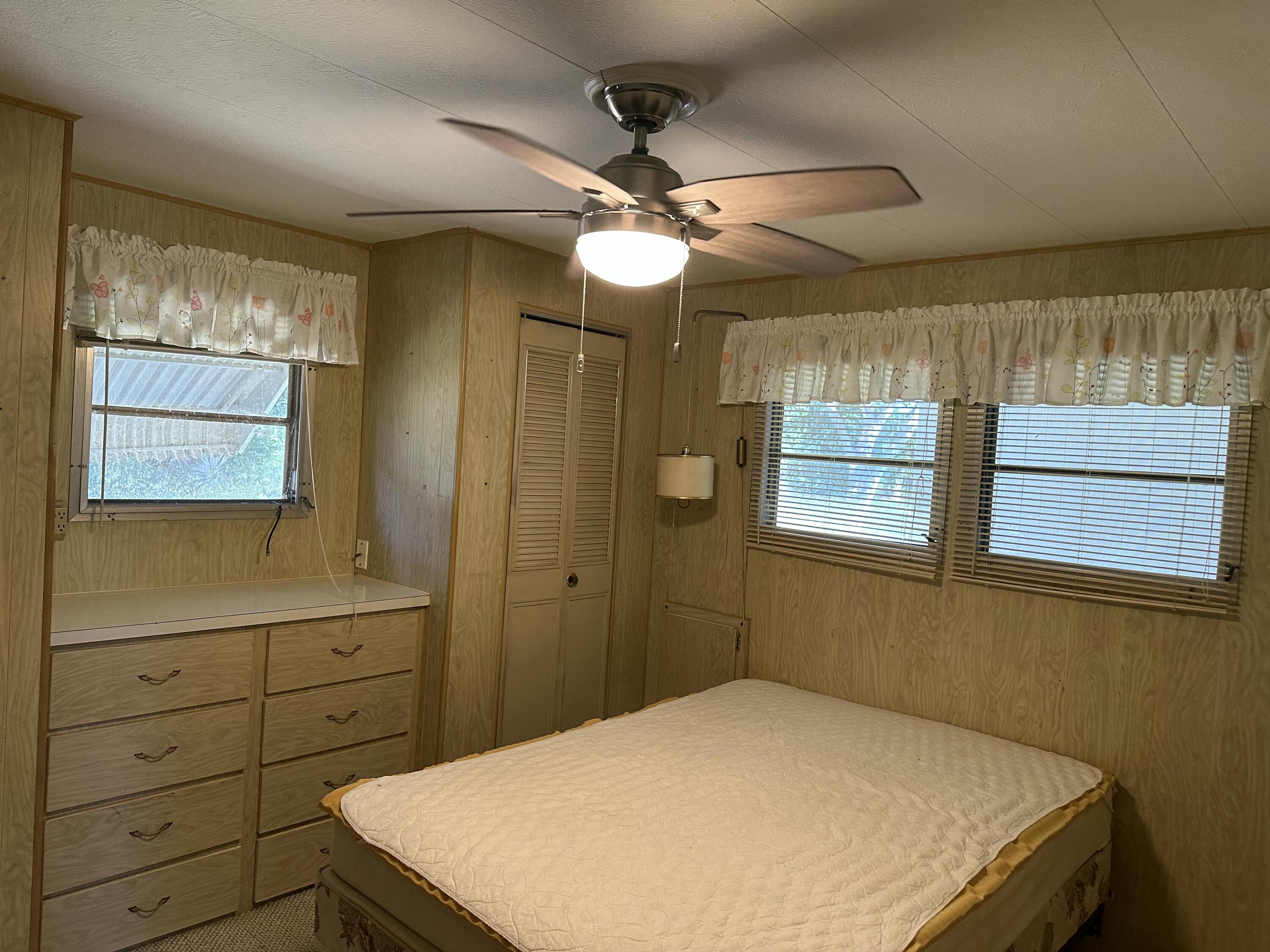 8435 East Club Road Boca Raton, FL 33433 - Photo 22 of 31 a bedroom with a bed and a cabinets